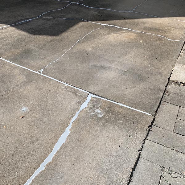 Concrete driveway control joints needing professional joint sealant after repair
