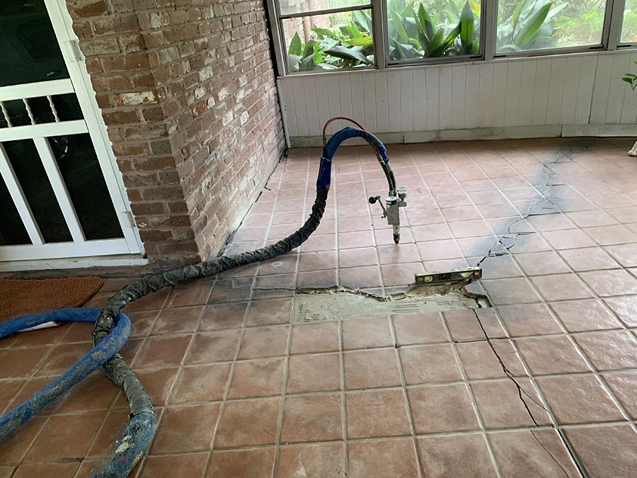 Patio with sinking and uneven concrete before repair