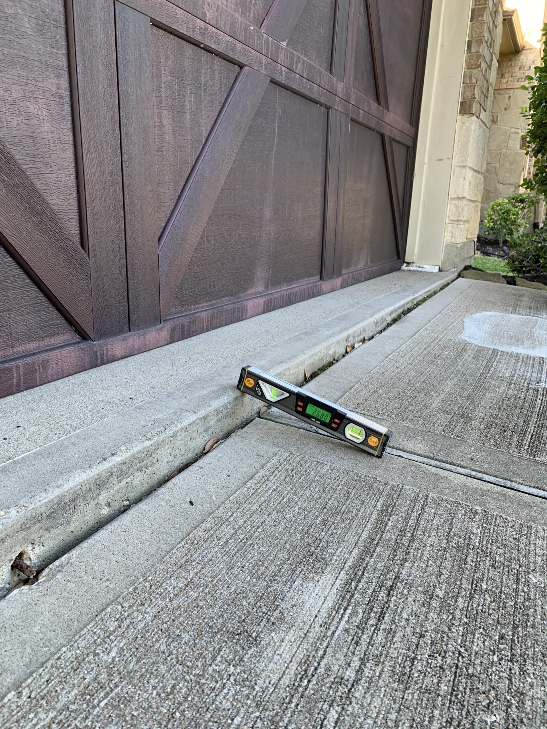 Residential concrete lifting and leveling on a driveway by Ro-Berg in the Houston Gulf Coast