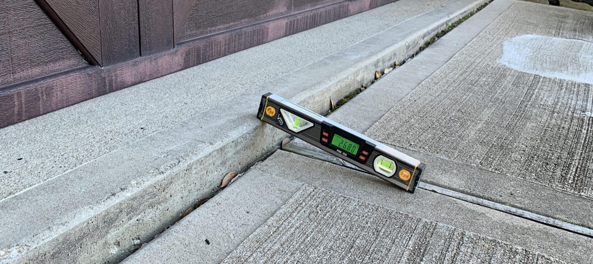 Ro-Berg technician leveling sunken concrete with polyurethane foam injection